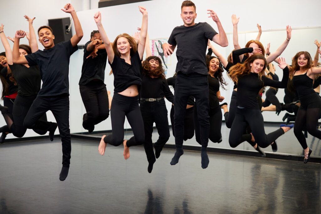 Male And Female Students At Performing Arts School Rehearsing Street Dance In Studio